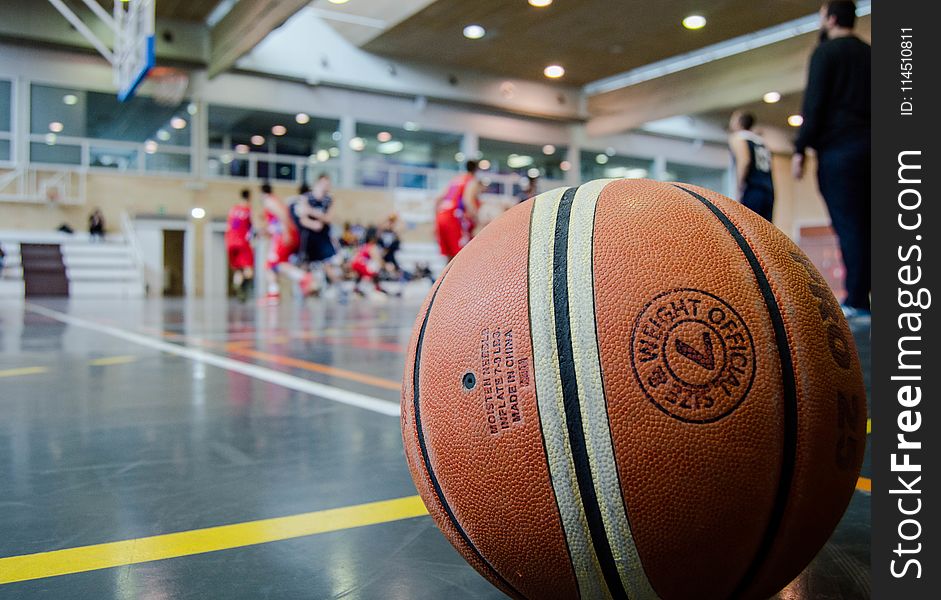 Brown Basketball On Grey Floor