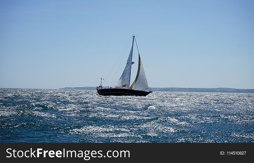 White and Black Sail Boat on Ocean