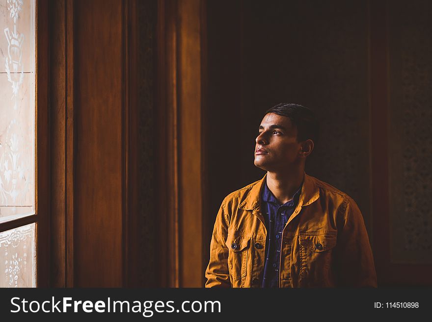 Photo Of Man Looking Towards Window