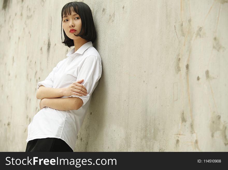 Woman Leaning on Concrete Wall