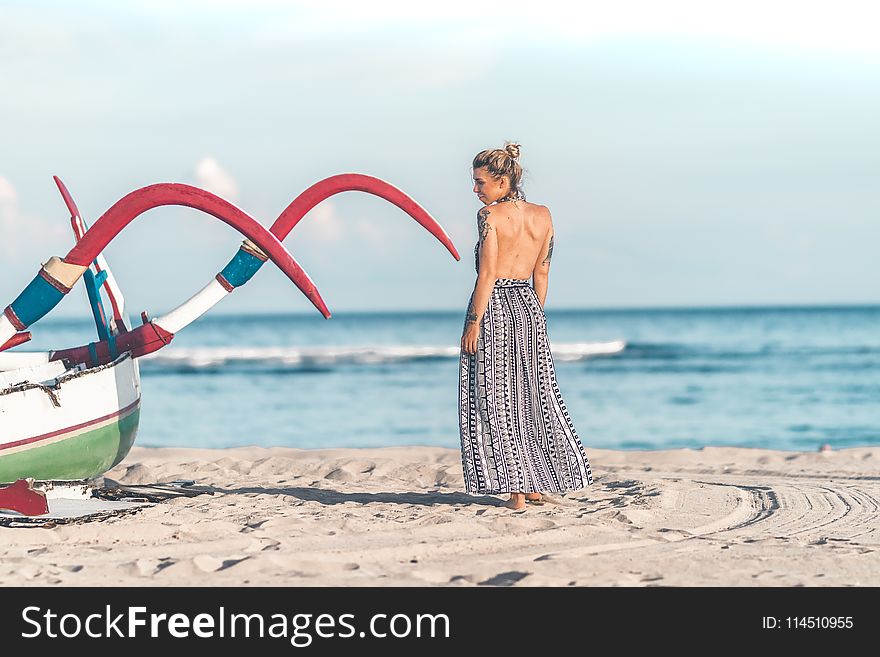 Photo of Woman Standing on Seashore