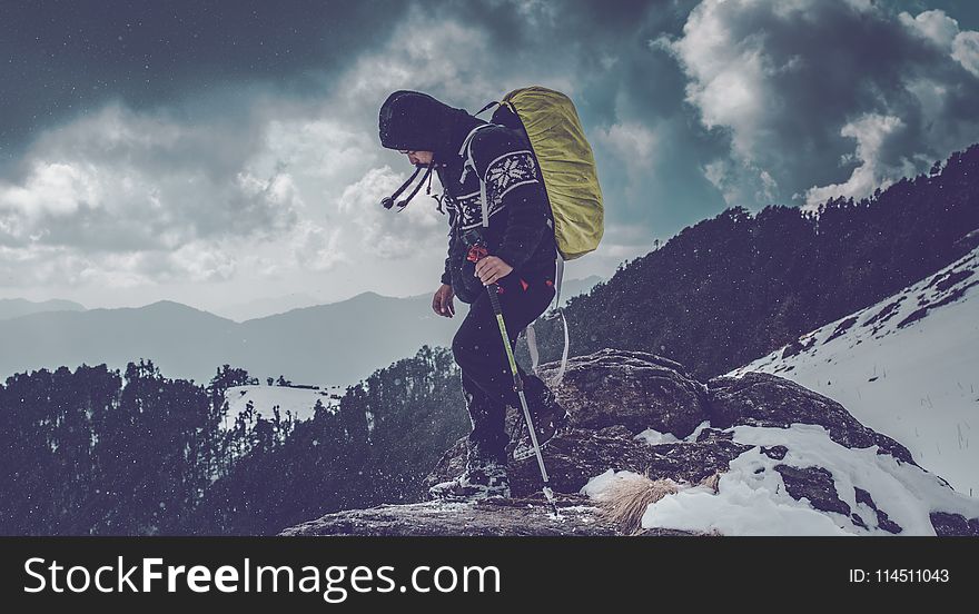 Man Wearing Black Hoodie On Rock Edge