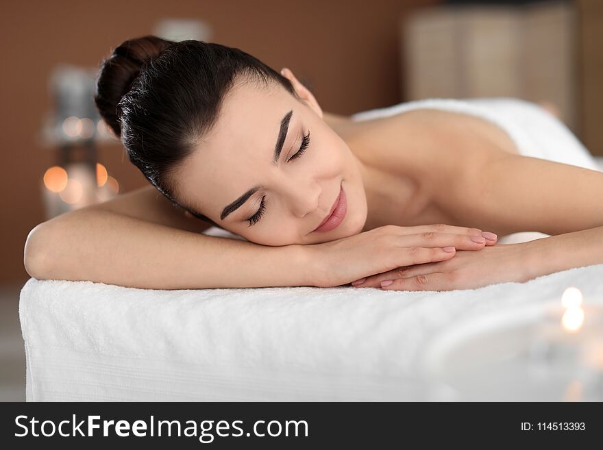 Young woman lying on massage table