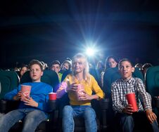 Free Youth Watching Film And Eating Snacks In Movie Theatre. Stock Photo - 114534890