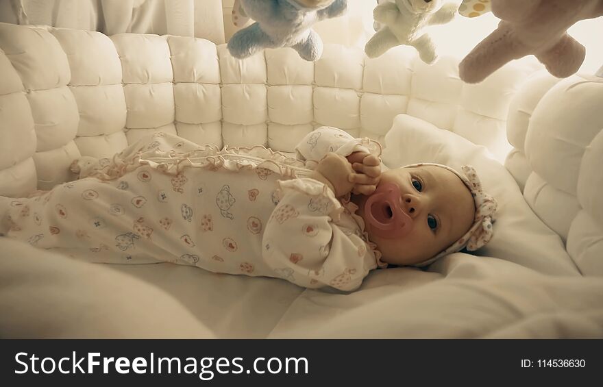 Newborn baby girl in her cot. Newborn baby girl in her cot
