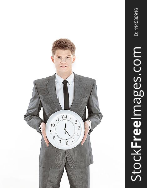 Handsome businessman holding a large clock.isolated on a white background