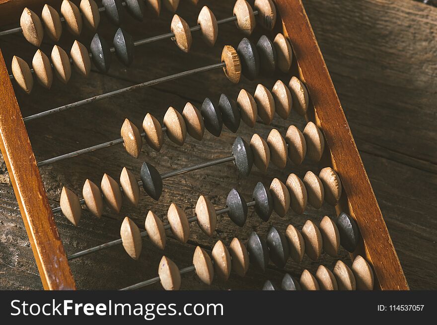 Vintage abacus on an wooden background photo. Vintage abacus on an wooden background photo