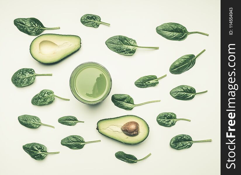 Concept of healthy eating, spinach leaves, avocado, smoothies on white background, flat lay