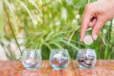 Hand Of Female Putting Coins In Jar With Money Stack Step Growing Growth Saving Money Stock Photo
