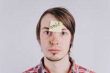 Sad Man Looks Directly, The Sticker Is Glued On The Forehead With The Word Credit . A Young Guy Is Upset By Debt, Credit Stock Photography