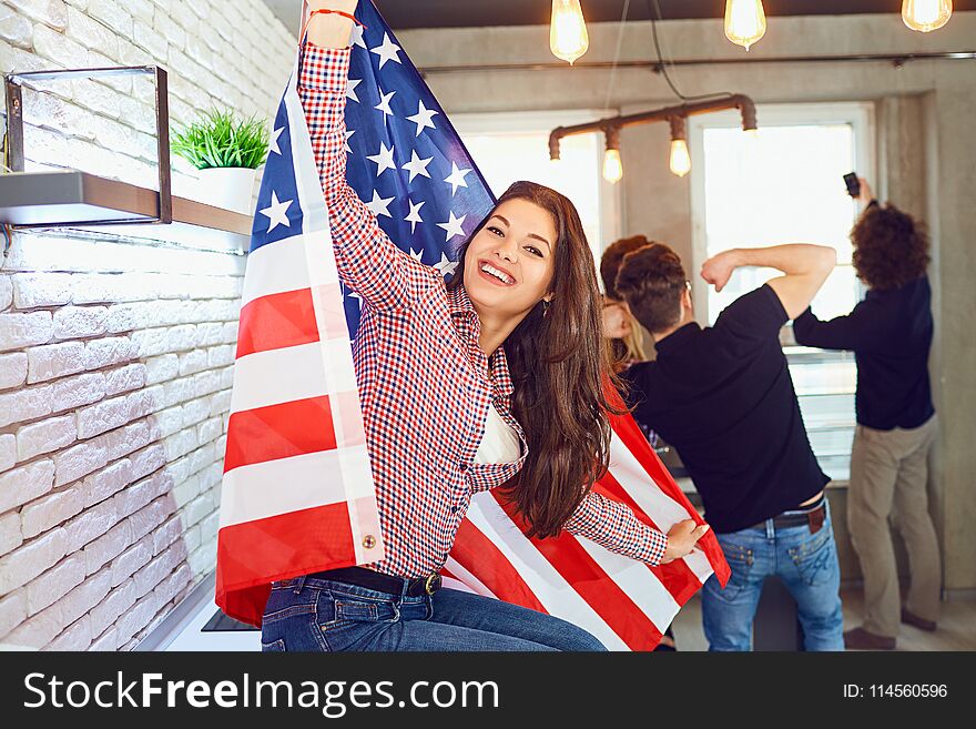 Girl with a beautiful smile with the flag of america indoors.