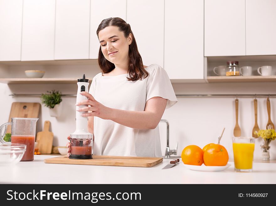 Pleased Appealing Woman Making Smoothie