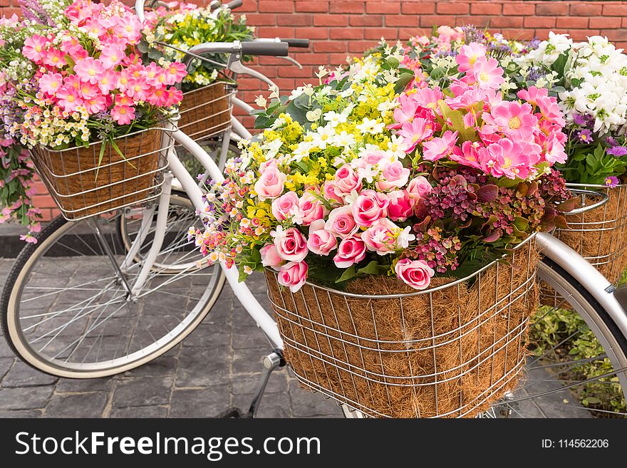 Beautiful colorful flowers in a basket of white vintage bicycle, Concept for wedding and valentine `s day. Beautiful colorful flowers in a basket of white vintage bicycle, Concept for wedding and valentine `s day.