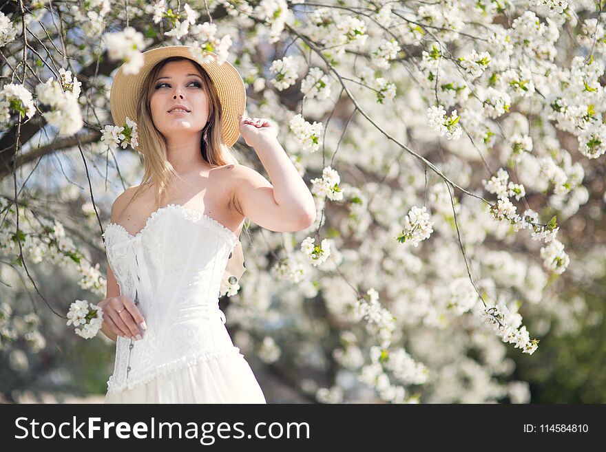Young long-haired woman in the garden blooming in spring. Young long-haired woman in the garden blooming in spring
