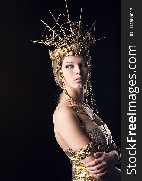 Young woman in golden crown