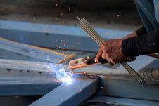 Asian Worker Making Sparks While Welding Steel Stock Photos