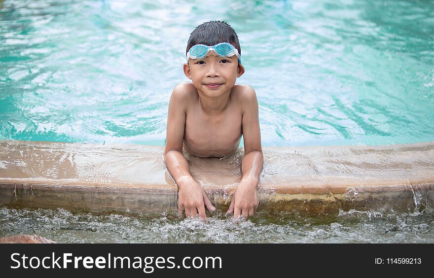 Cute child playing and swimming on summer holidays.