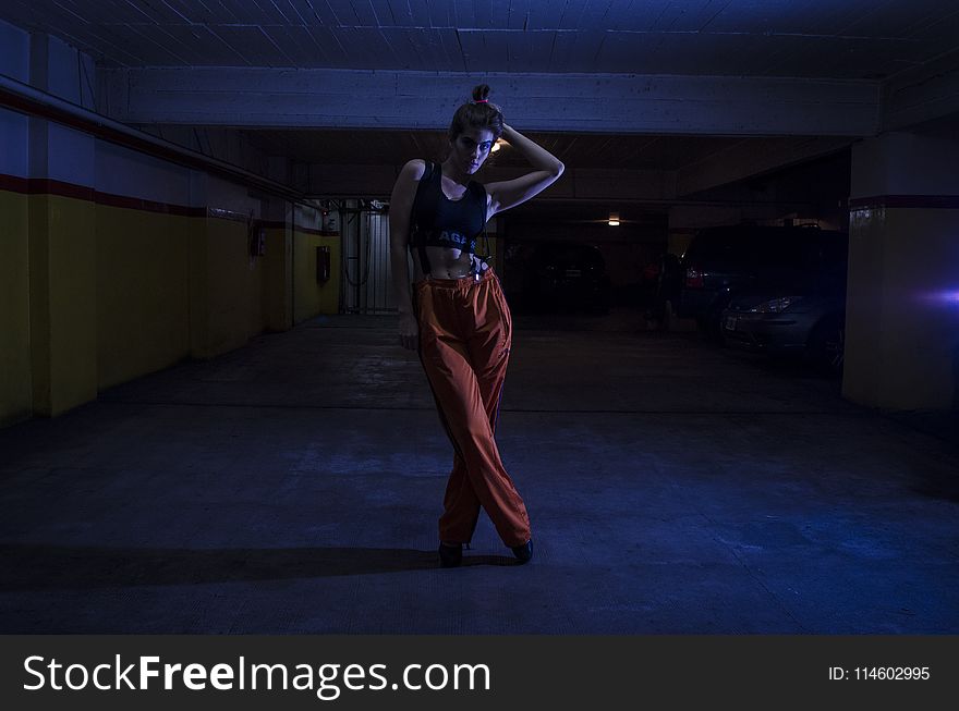 Woman Wearing Black Crop-top And Orange Pants Inside Parking Lot