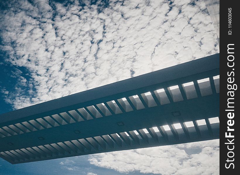 Silhouette of Bridge Under Cloudy Sky