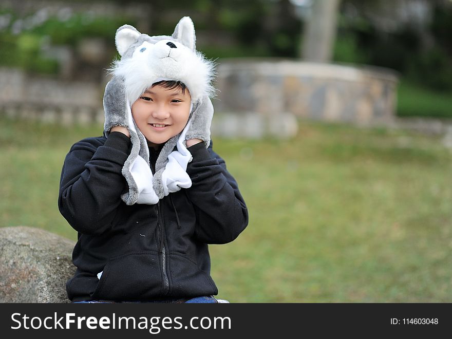 Kid Wearing Gray Wolf Critter Hat and Black Jacket