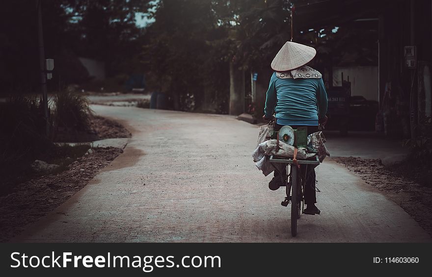 Person in Blue Long-sleeves Riding Bicycle