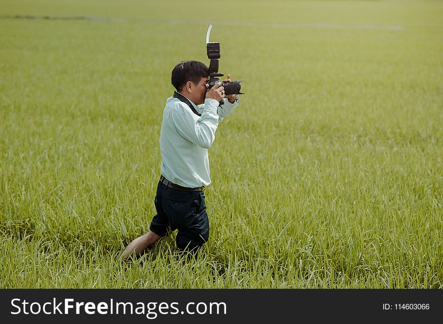 Man Taking Photos in the Field