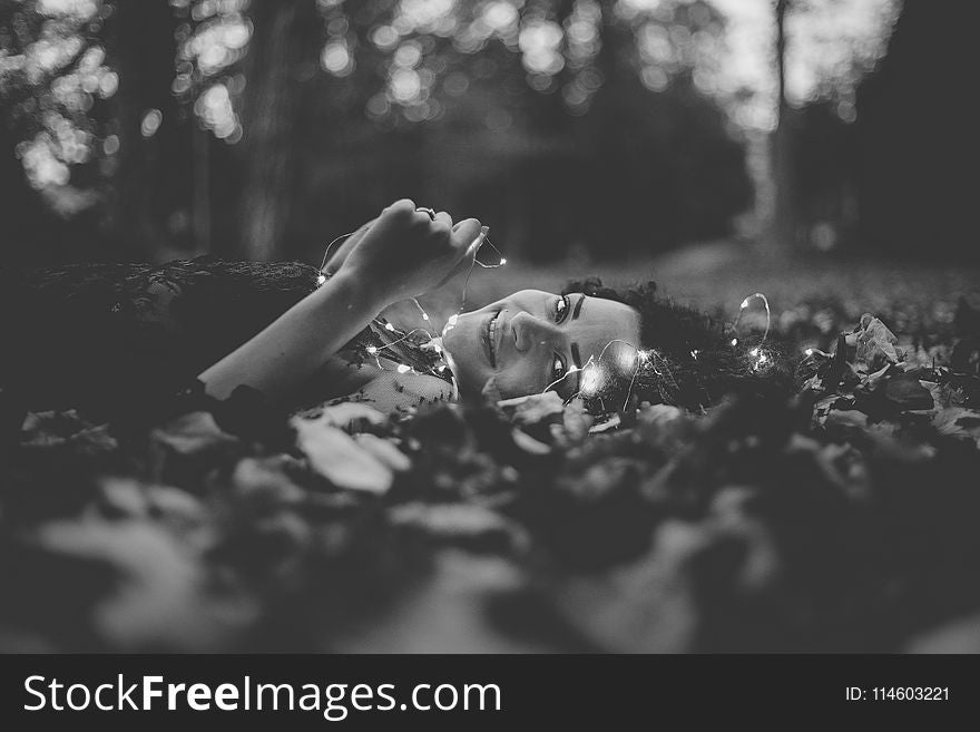 Grayscale Photo of Person Lying on Ground