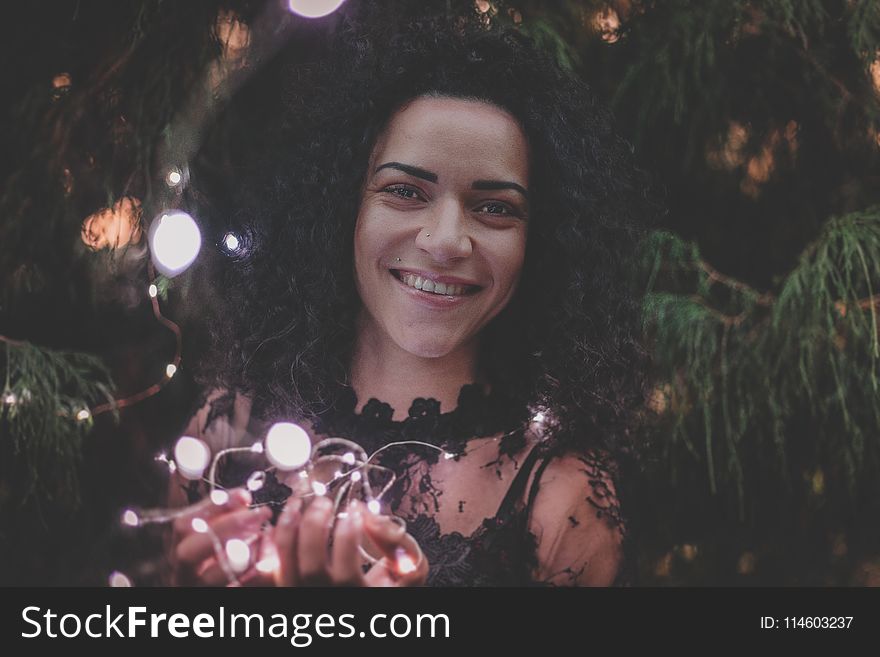 Close-U Photography of a Woman Holding String Lights
