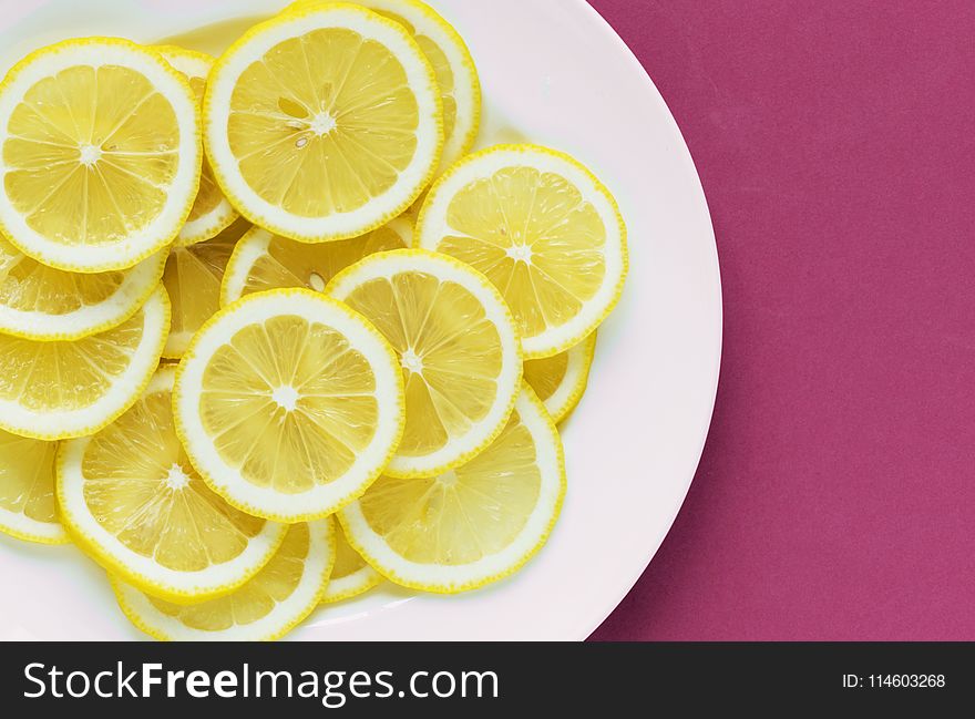 Photo of Sliced Lemons on White Plate