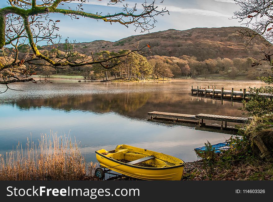 Landscape Photography Of Yellow Punt Boat On Shoreline