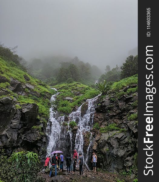 People In Front Of Waterfalls