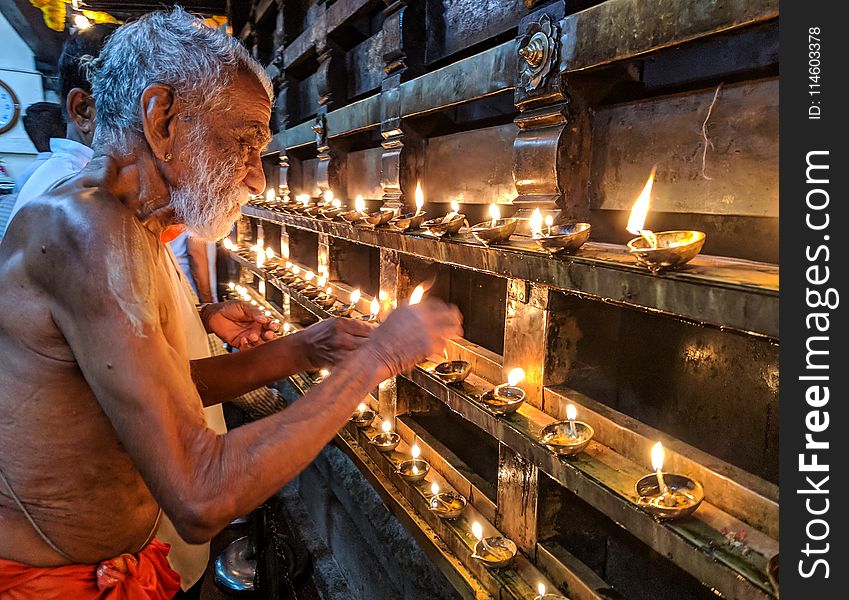 Man Lighting Candles
