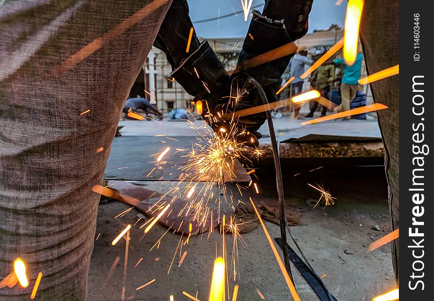 Man Cutting Steel Using A Power Tool