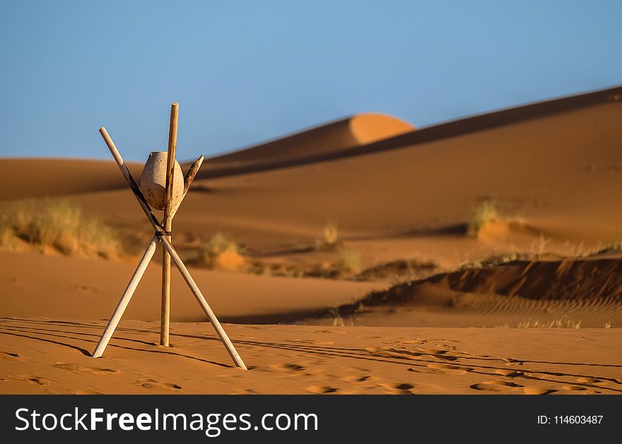 Brown Stone on Tripod Sticks at a Desert