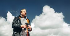Travel Search Concept. Hiking Man With Beard Holds Binoculars In Royalty Free Stock Images