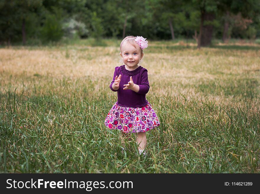 Portrait of little girl standing in green grass. Portrait of little girl standing in green grass