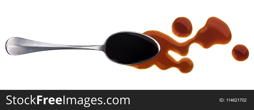 Soy sauce. Splashes and spilled soy sauce with spoon isolated on white background. Top view