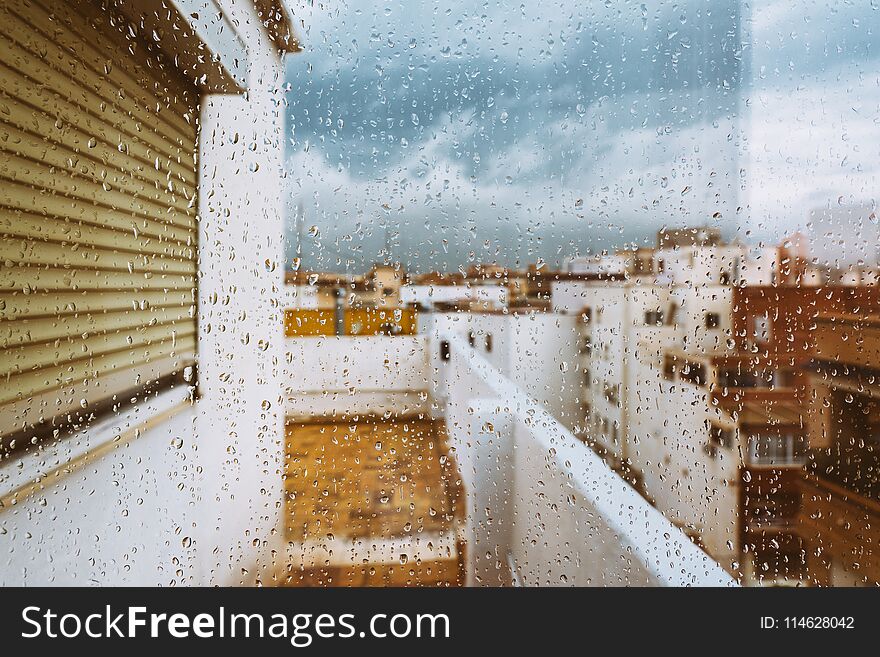 Window With Raindrops On It, Overlooking The Terrace. Stormy Sky