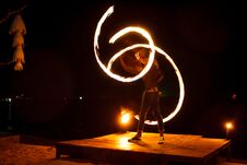 Street Artist Fire Juggling Performance. Light Painting And Long Exposure Picture To Form Trails. Phi Phi Island, Thailand. Royalty Free Stock Images