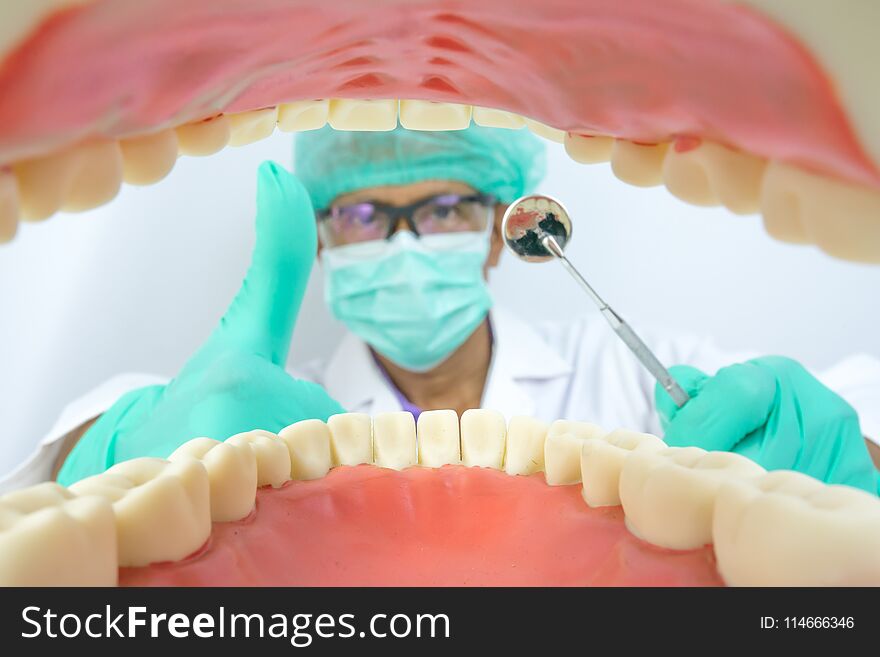 Dentist examine oral cavity with dental tool,mirror and hook