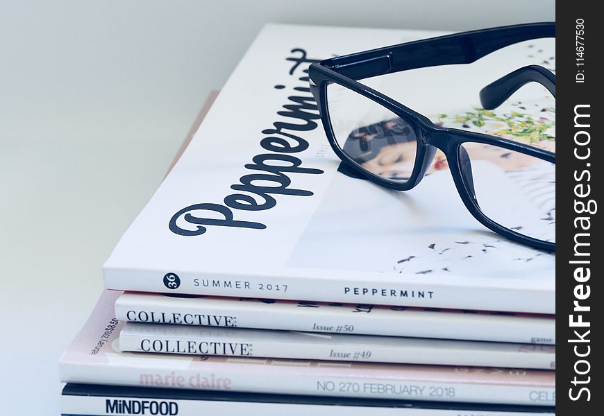 Photo of Eyeglasses On Top of Magazines