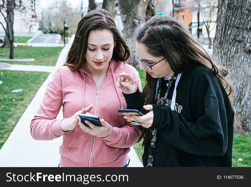 Photography Of Women Using Mobile Phones