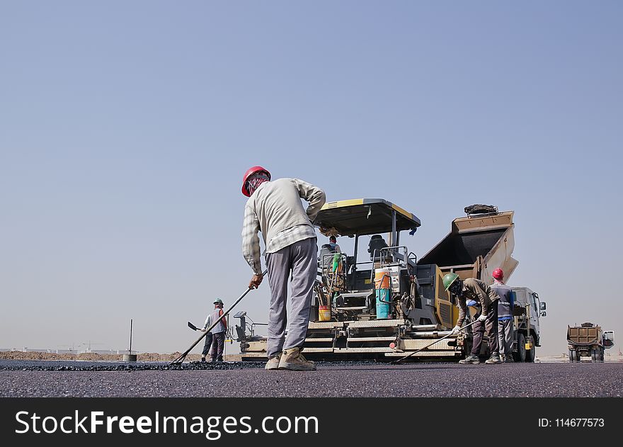 Group of Men Repairing a Road