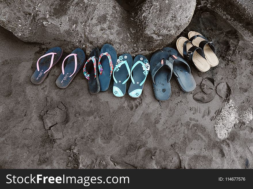 Assorted Flip-flops on Sand