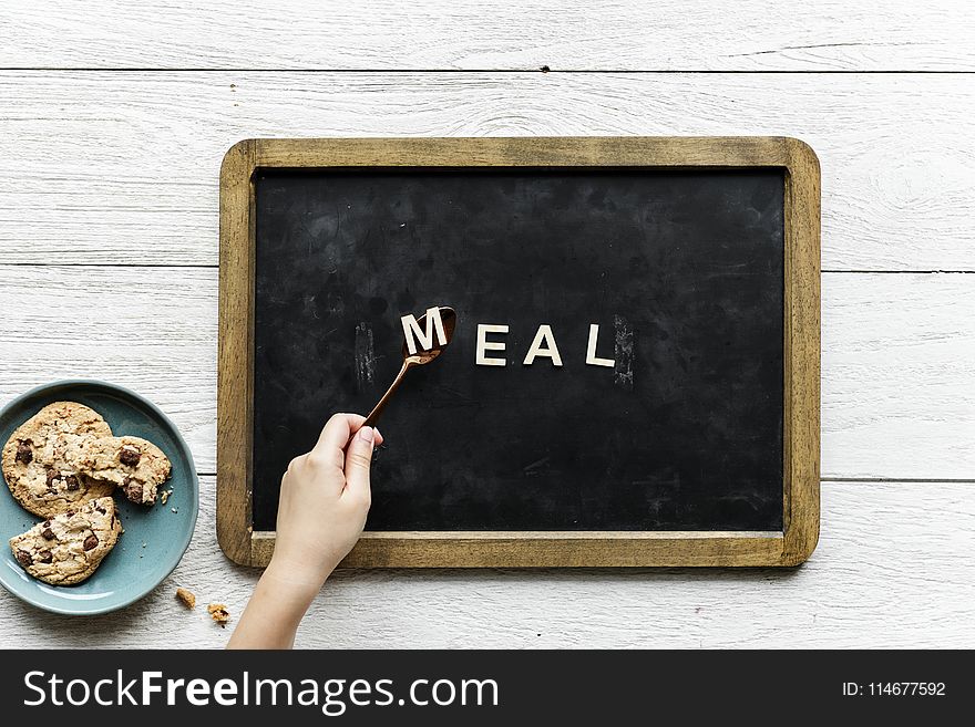 Person Holding Black and Brown Food Tray