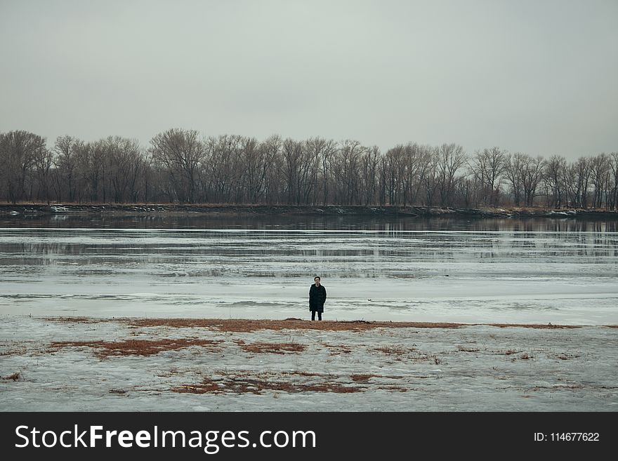 Person Standing Near Body of Water