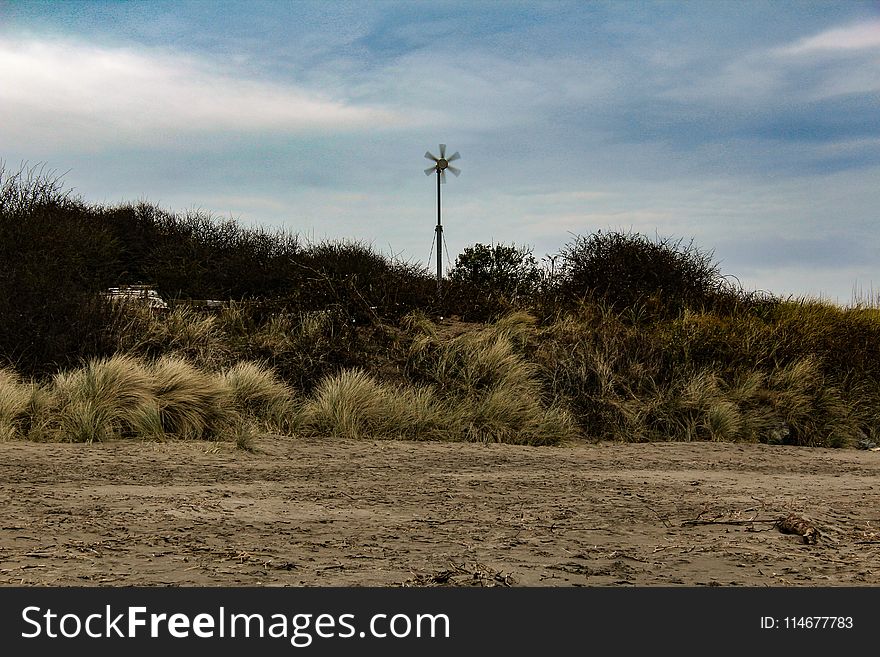 Windmill Surrounded By Grass