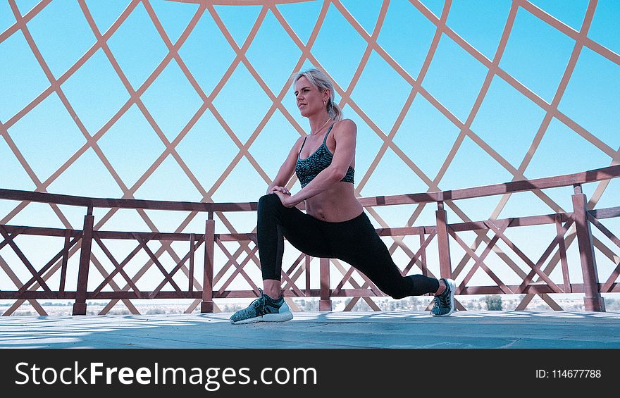 Woman in Green Sports Bra and Black Leggings Doing Leg Lunges
