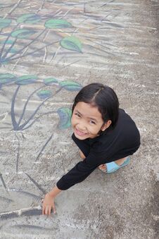 A Little Girl With A Smile Sitting On A Painted Cement Backgroun Stock Photos