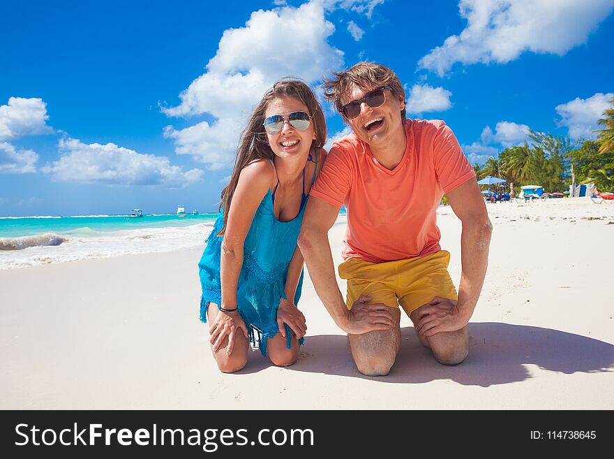 Closeup Of Happy Young Caucasian Couple In Bright Clothes Laughing At Beach